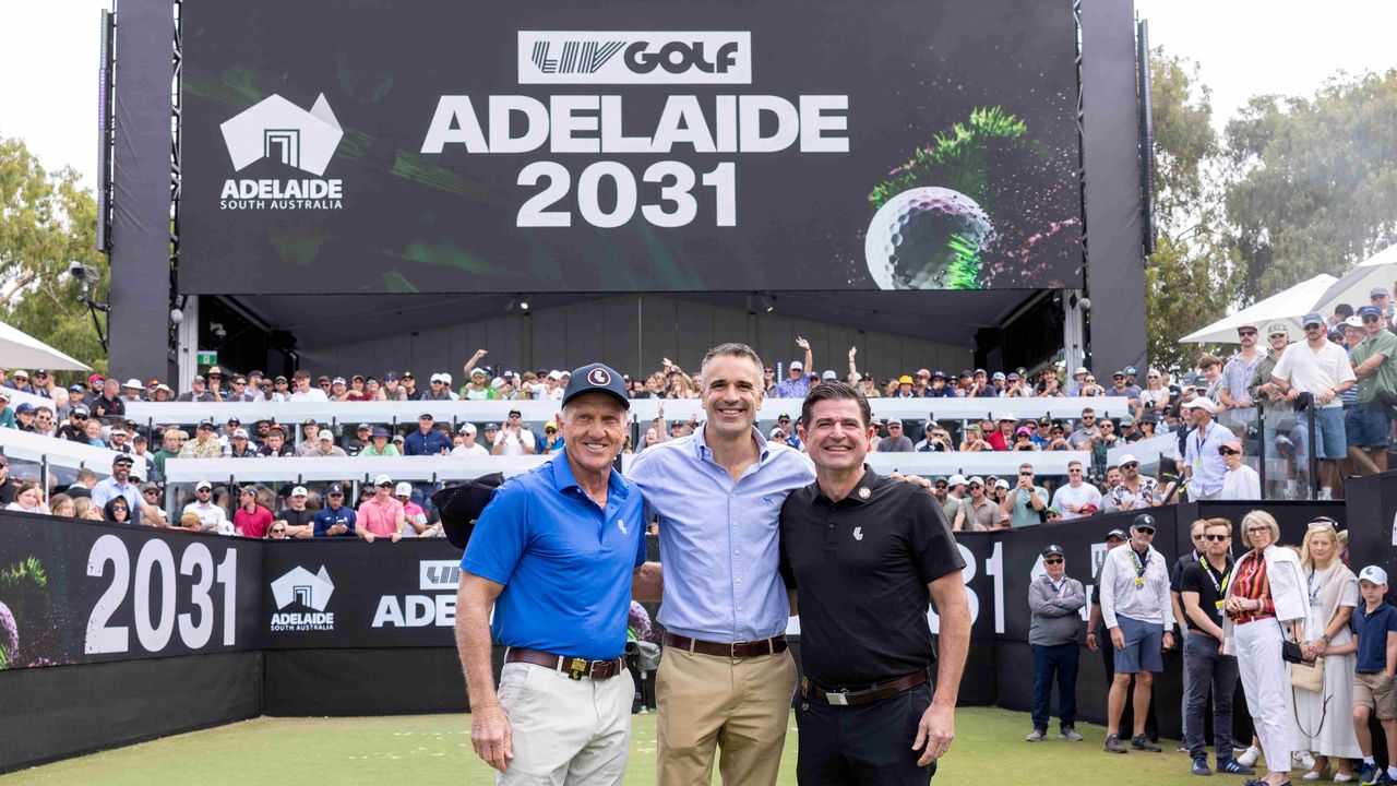 (L to R) Greg Norman, Peter Malinauskas and Scott O&#039;Neil stand in front of a large LIV Golf Adelaide 2031 sign behind &#039;The Watering Hole&#039; at The Grange Golf Club