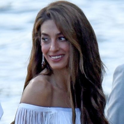 Amal Clooney arrived in Lake Como wearing a fringed white dress