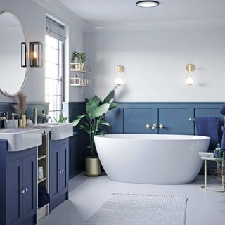 blue and white bathroom with wall lights