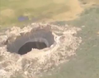 A Siberian hole that opened up mysteriously and was reported in July 2014.