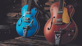 Close up of a blue and and orange Gretsch Brian Setzer Signature model Gretsch hollowbody on a wooden background leant against a wall