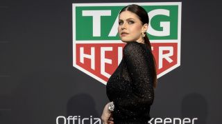 Alexandra Daddario at Formula 1 event in black sheer dress 2025.