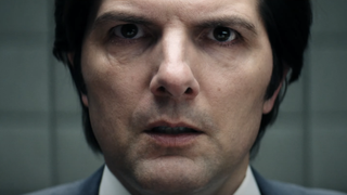 Adam Scott looks at the camera alarmed in Severance season 2