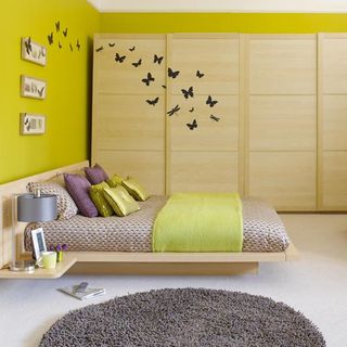 bedroom with sliding wardrobe doors and wall stickers