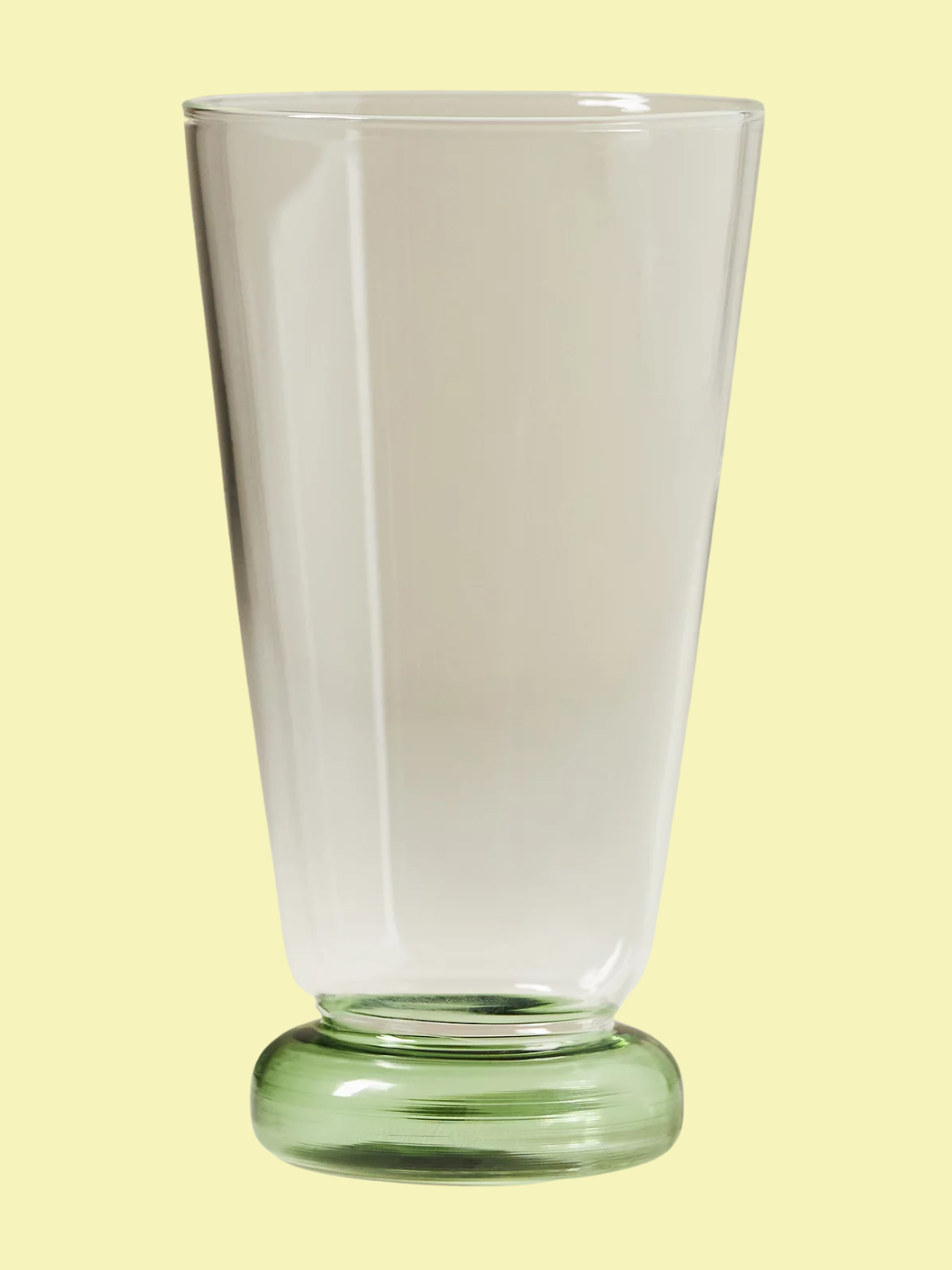 A highball glass with a green base from Anthropologie