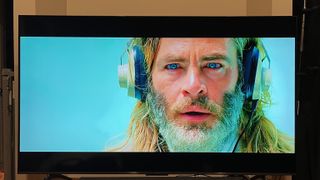 TCL QM6K showing image of man with headphones