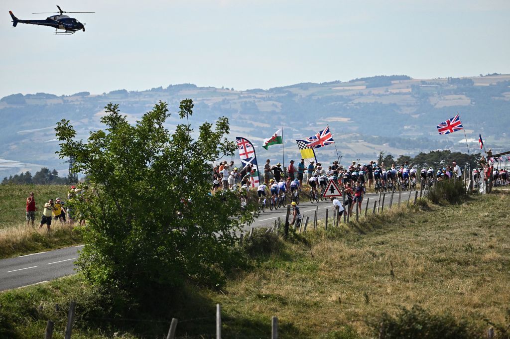 The pack of riders cycles during the 13th stage of the 109th edition of the Tour de France cycling race 1926 km between Le Bourg dOisans in the French Alps and SaintEtienne in central France on July 15 2022 Photo by Marco BERTORELLO AFP Photo by MARCO BERTORELLOAFP via Getty Images