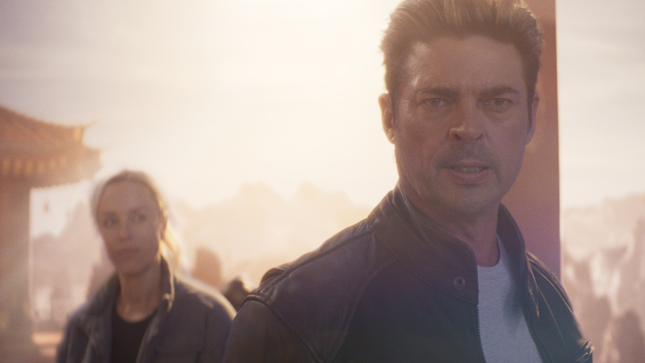 Jessica McNamee looks at a determined Karl Urban in an early morning scene Mortal Kombat II.