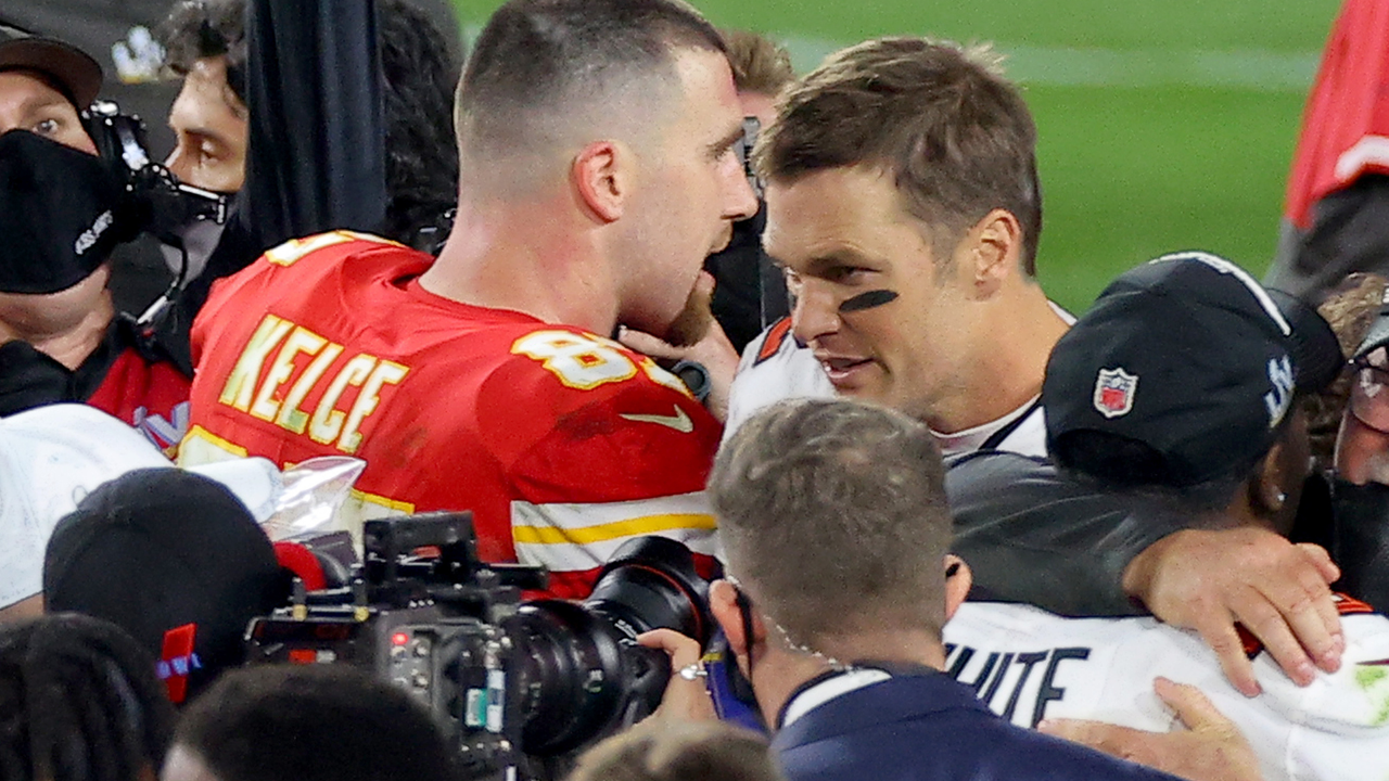 Travis Kelce #87 of the Kansas City Chiefs and Tom Brady #12 of the Tampa Bay Buccaneers speak after Super Bowl LV at Raymond James Stadium on February 07, 2021 in Tampa, Florida.