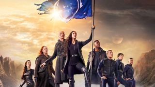 The cast of Star Trek Discovery on a planet's surface around a raised flag, in show art for season 3