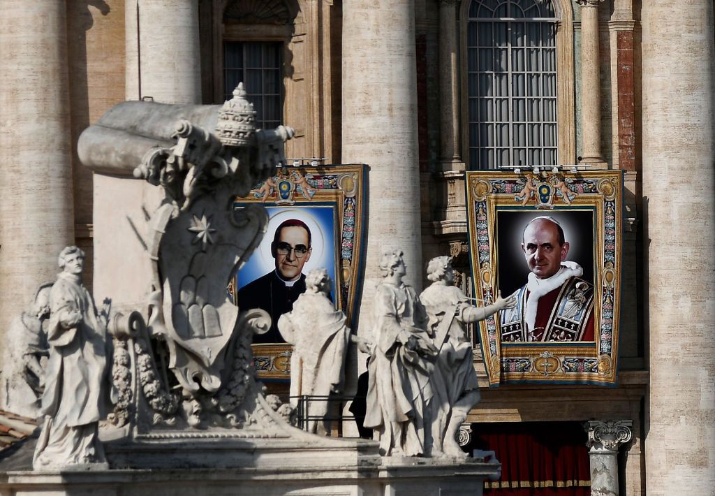 Portraits of Pope Paul VI (R) and the martyred Salvadoran Archbishop Oscar Romero (L) are seen during a canonization ceremony mass in St Peter&amp;#039;s Square at the Vatican, on October 14, 2018. 