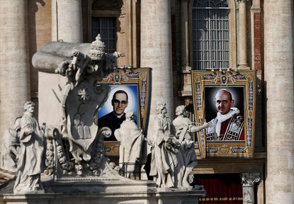 Portraits of Pope Paul VI (R) and the martyred Salvadoran Archbishop Oscar Romero (L) are seen during a canonization ceremony mass in St Peter's Square at the Vatican, on October 14, 2018. 