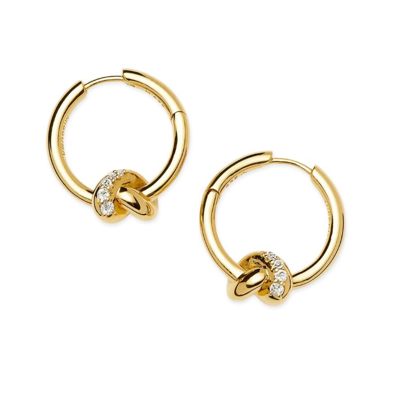 A cutout of gold and pave knot hoop earrings