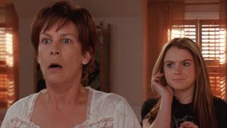 From left to right: Jamie Lee Curtis looking shocked and Lindsay Lohan holding her left hand up to her ear in Freaky Friday. 