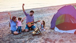 best campfire songs: family around a campfire