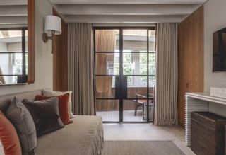 A living room with Crittal glazing between two rooms