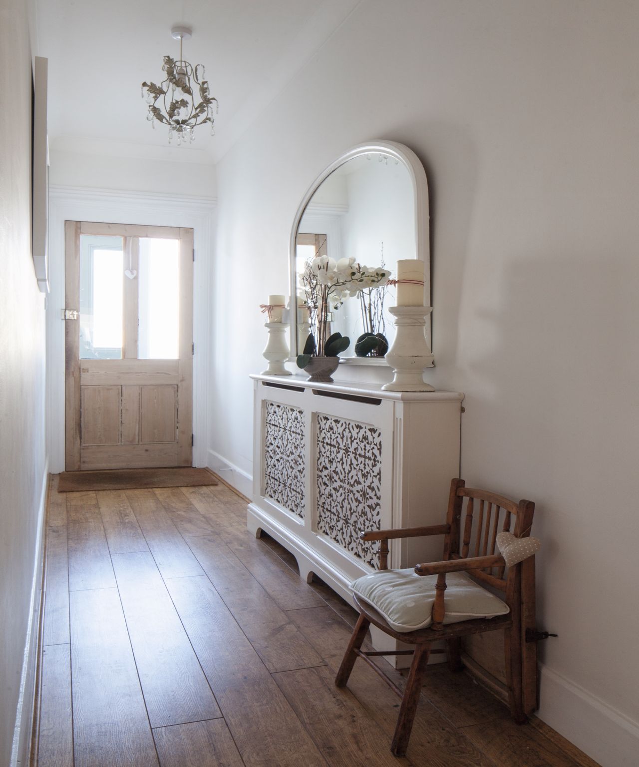Neutral entryway with radiator and cover, wooden entryway chair