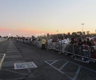A crowd waits for shuttle Endeavour in a designated viewing lot near its museum home on Oct. 13, 2012, the day it was originally scheduled to arrive.