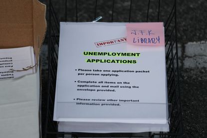 Unemployment applications are seen as City of Hialeah employees hand them out to people in front of the John F. Kennedy Library on April 08, 2020 in Hialeah, Florida