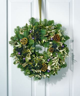 Fir and sage wreath with bark, pinecones, lotus heads, berries and baubles.