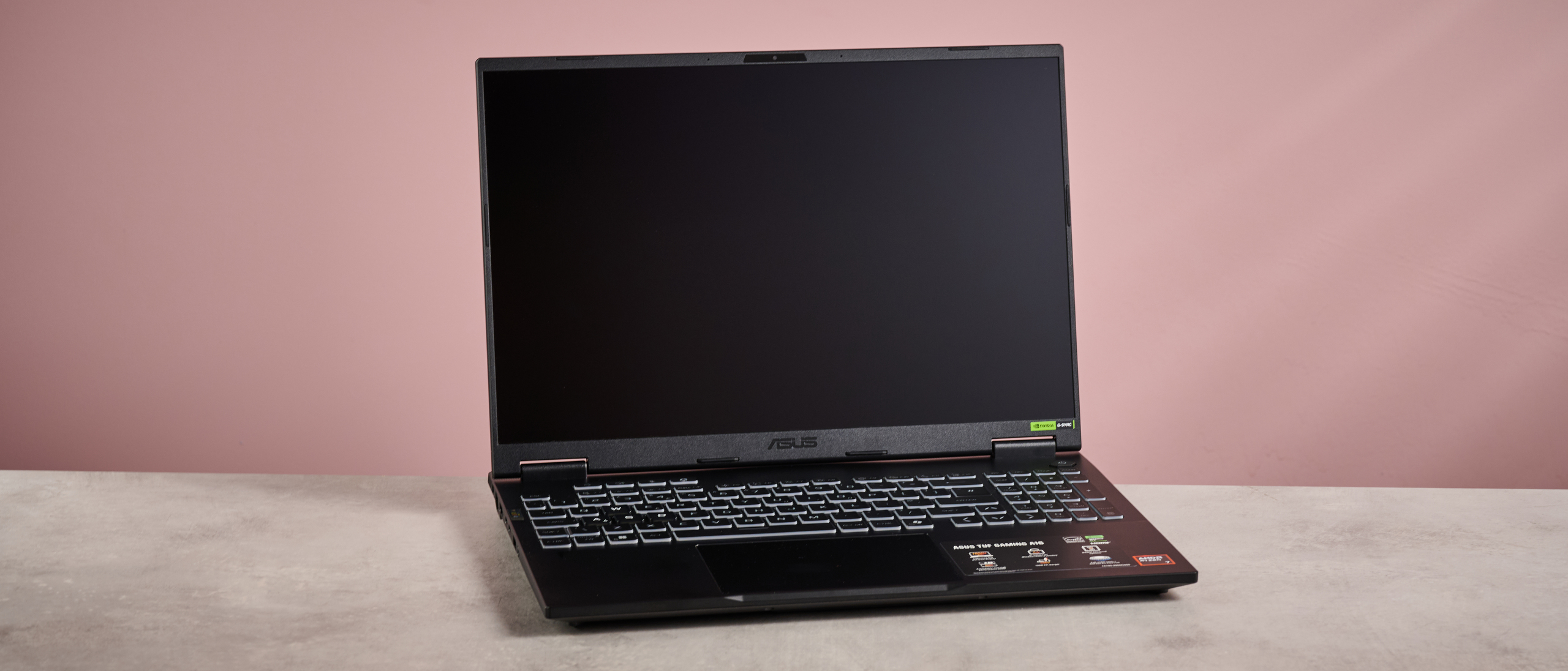 ASUS TUF Gaming A16 (2025) open on desk with pink background