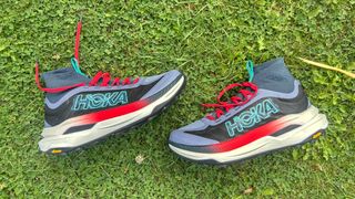 Hoka Tecton X3 trail running shoes on the side on grass