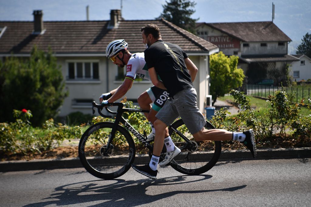 Team Bora rider Slovakias Peter Sagan is pushed by a staff member after a technical problem during the 17th stage of the 107th edition of the Tour de France cycling race 170 km between Grenoble and Meribel on September 16 2020 Photo by AnneChristine POUJOULAT AFP Photo by ANNECHRISTINE POUJOULATAFP via Getty Images