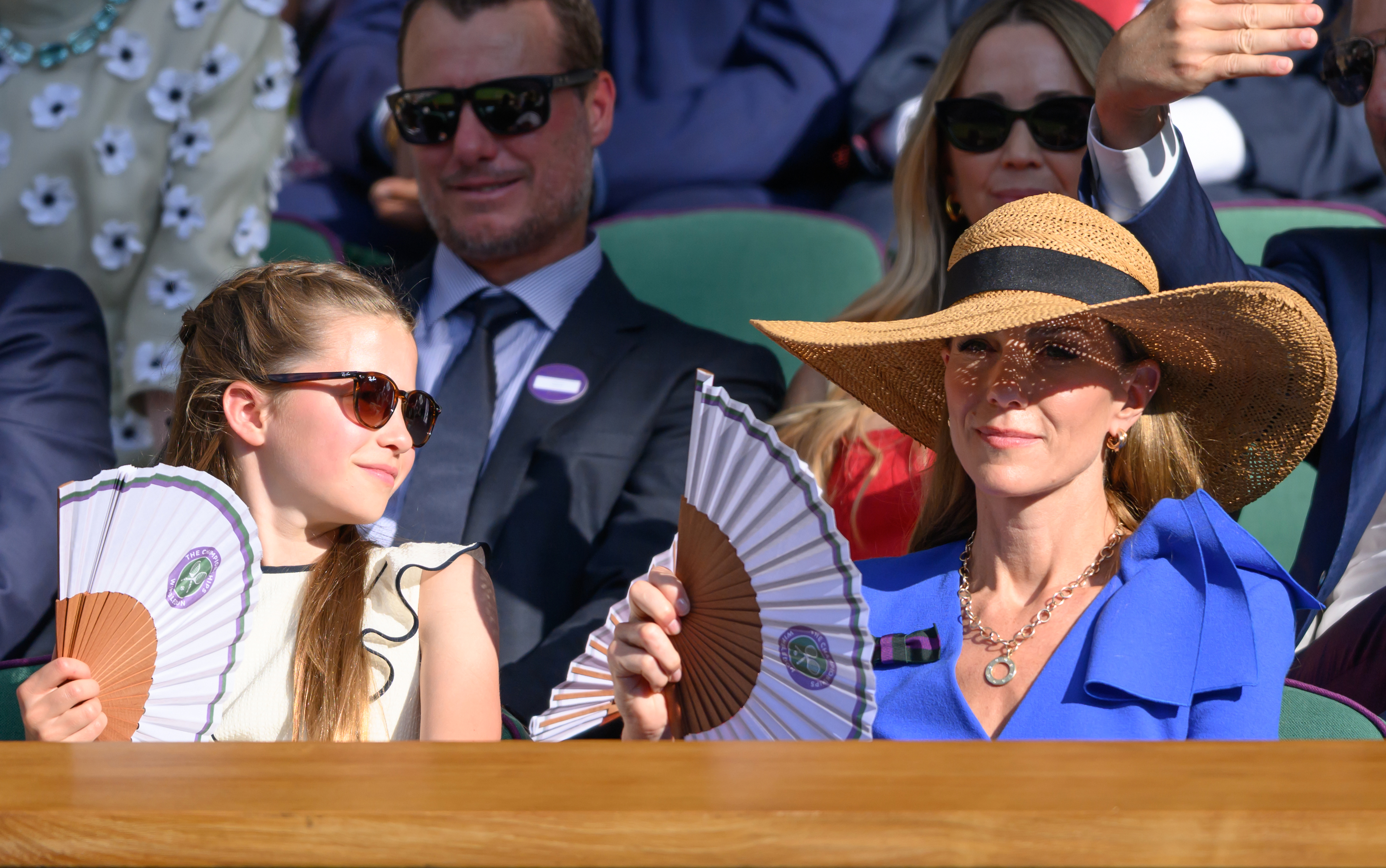 Princess Charlotte fans her mom Kate Middleton at Wimbledon as they watch the tennis tournament during a heat wave