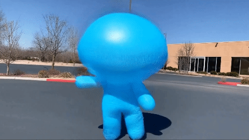 AI created video. Blue balloon man dancing in a parking lot
