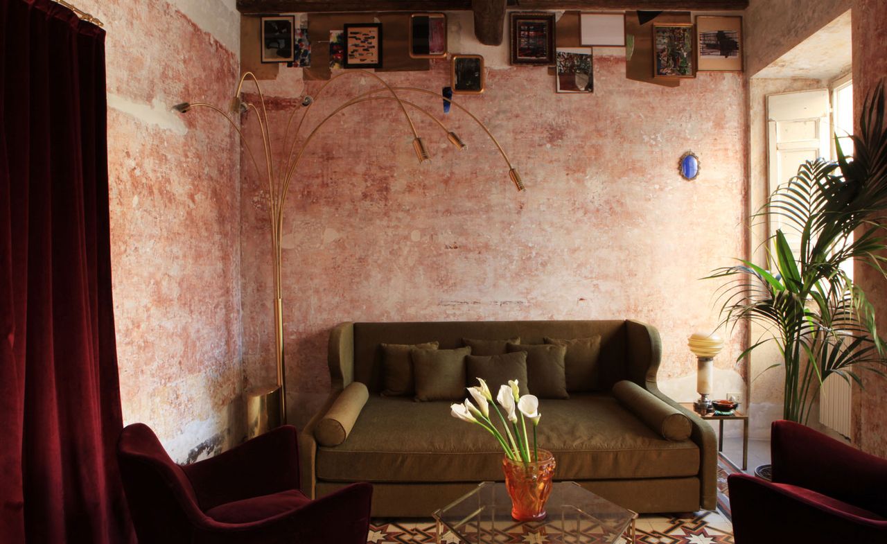 G-Rough lobby area with pink walls and brown sofa