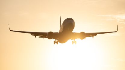 Aeroplane flying from a sunset