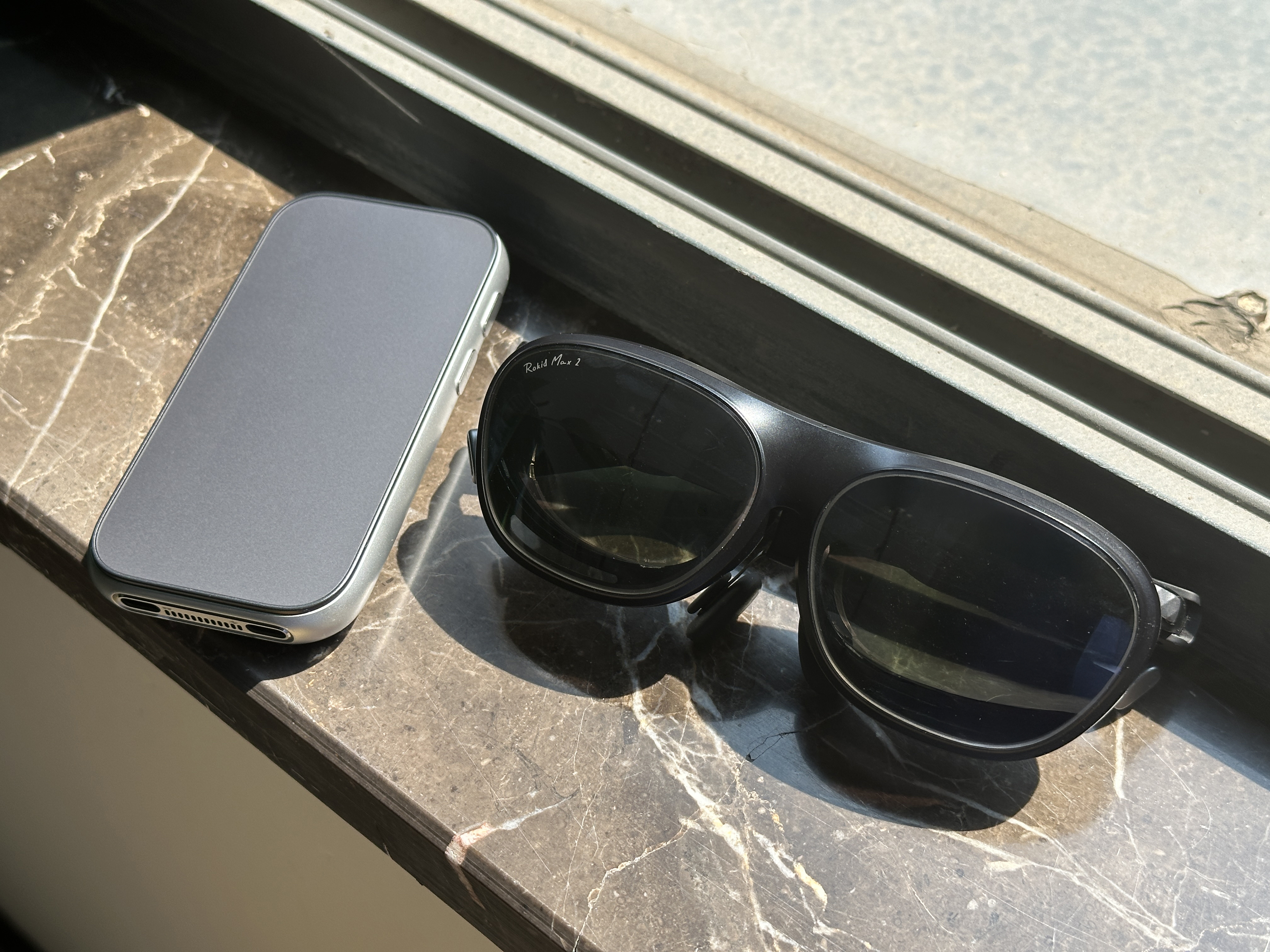 Rokid AR glasses in black alongside an external YodaOS-Master OS controller