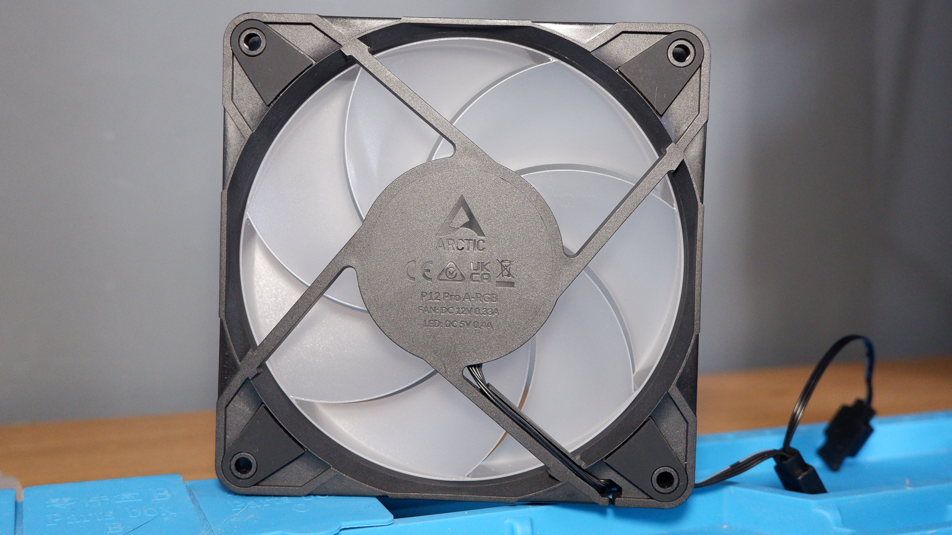 An Arctic P12 Pro fan on a soldering mat.