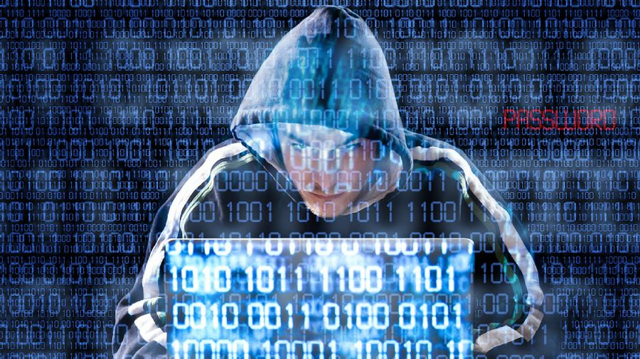 stereotypical hacker wearing a hoodie with a foreground and background of 1s and 0s overlaid on top
