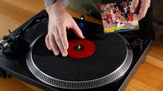 A Tiny Vinyl 4-inch record on a record player with the cover sleeve reading Beautiful Chaos by Katseye.