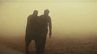 Two people wandering through the dusty desert in Kandahar.