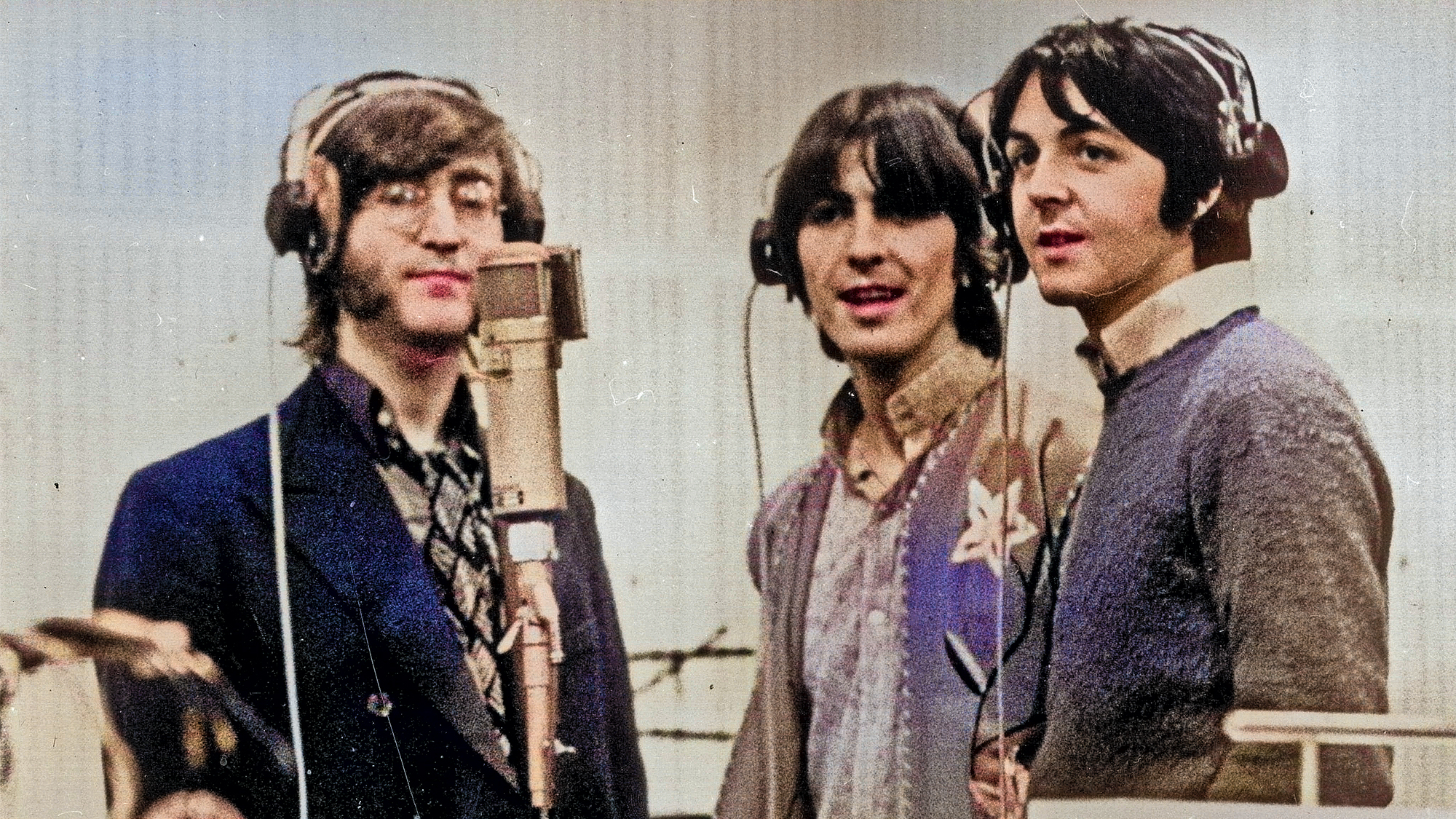 1968: Three Beatles; from left to right John Lennon (1940 - 1980), George Harrison (1943 - 2001) and Paul McCartney, record voices in a studio for their new cartoon film 'Yellow Submarine'. 