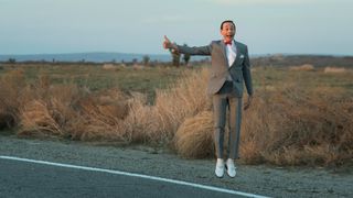 Pee-wee Herman hitchhiking in Pee-wee's Big Holiday, one of the best family movies on Netflix