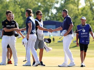 Zurich Classic final green with winners Cam Smith and Marc Leishman shaking hands with runner-up finishers Lois Oosthuizen and Charl Schwartzel
