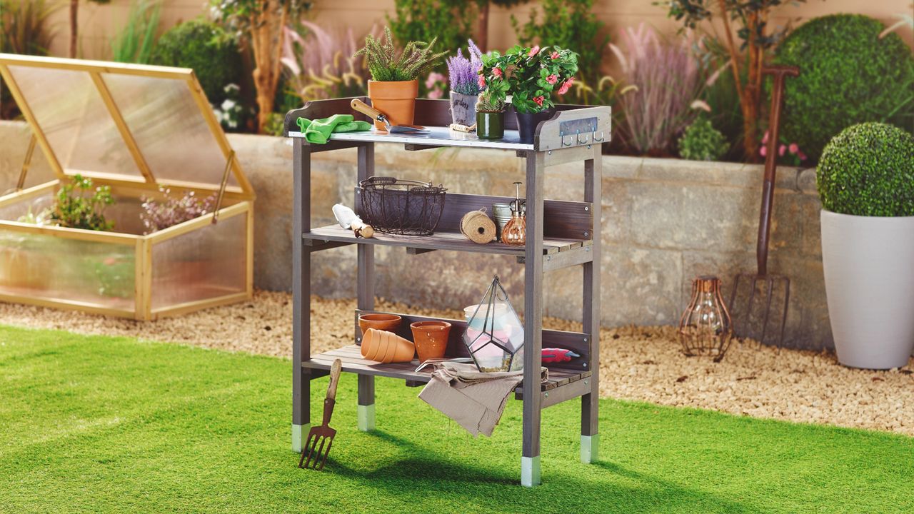 Aldi potting bench filled with various gardening items