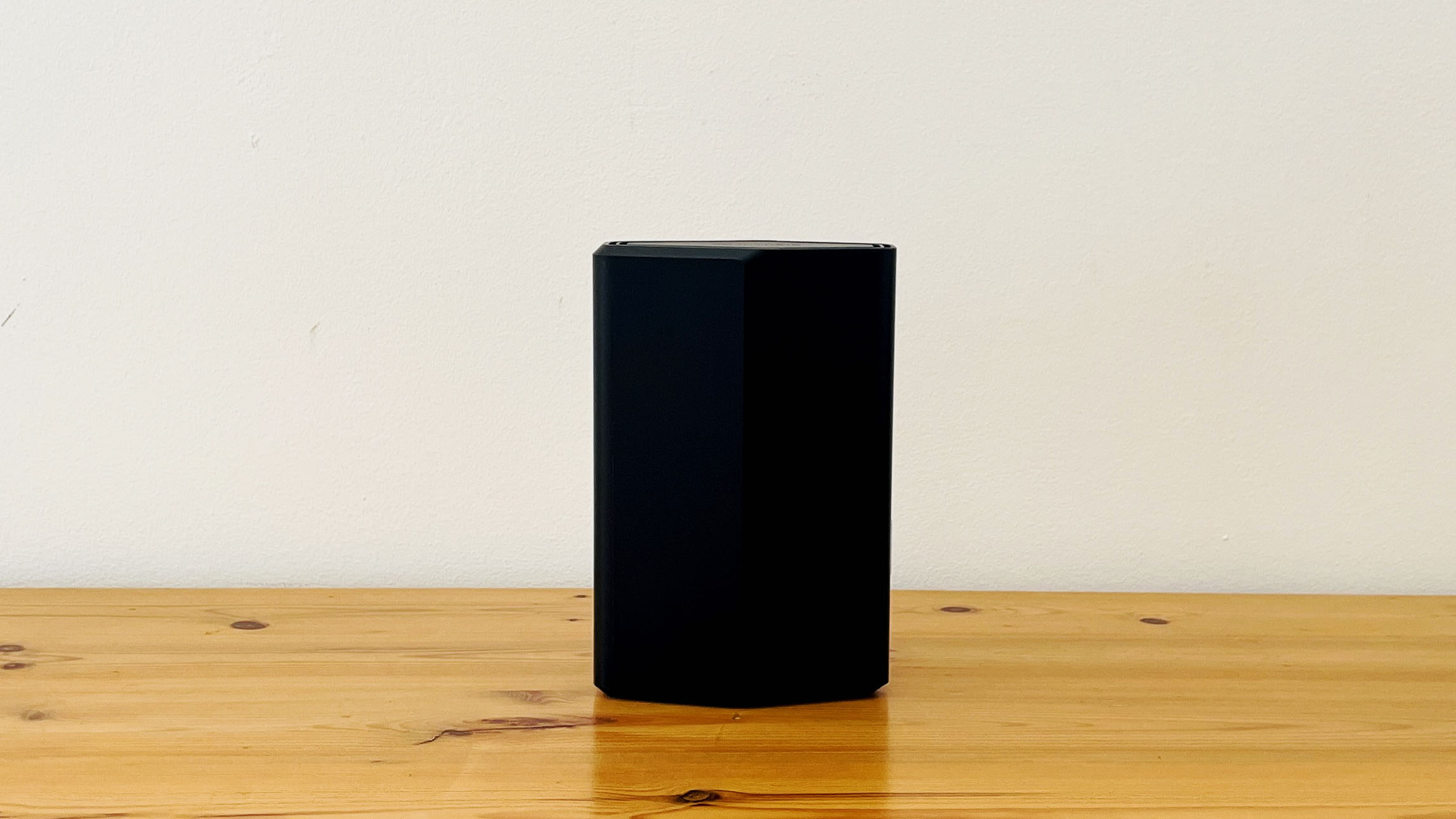 Netgear Nighthawk RS100 router on wooden table
