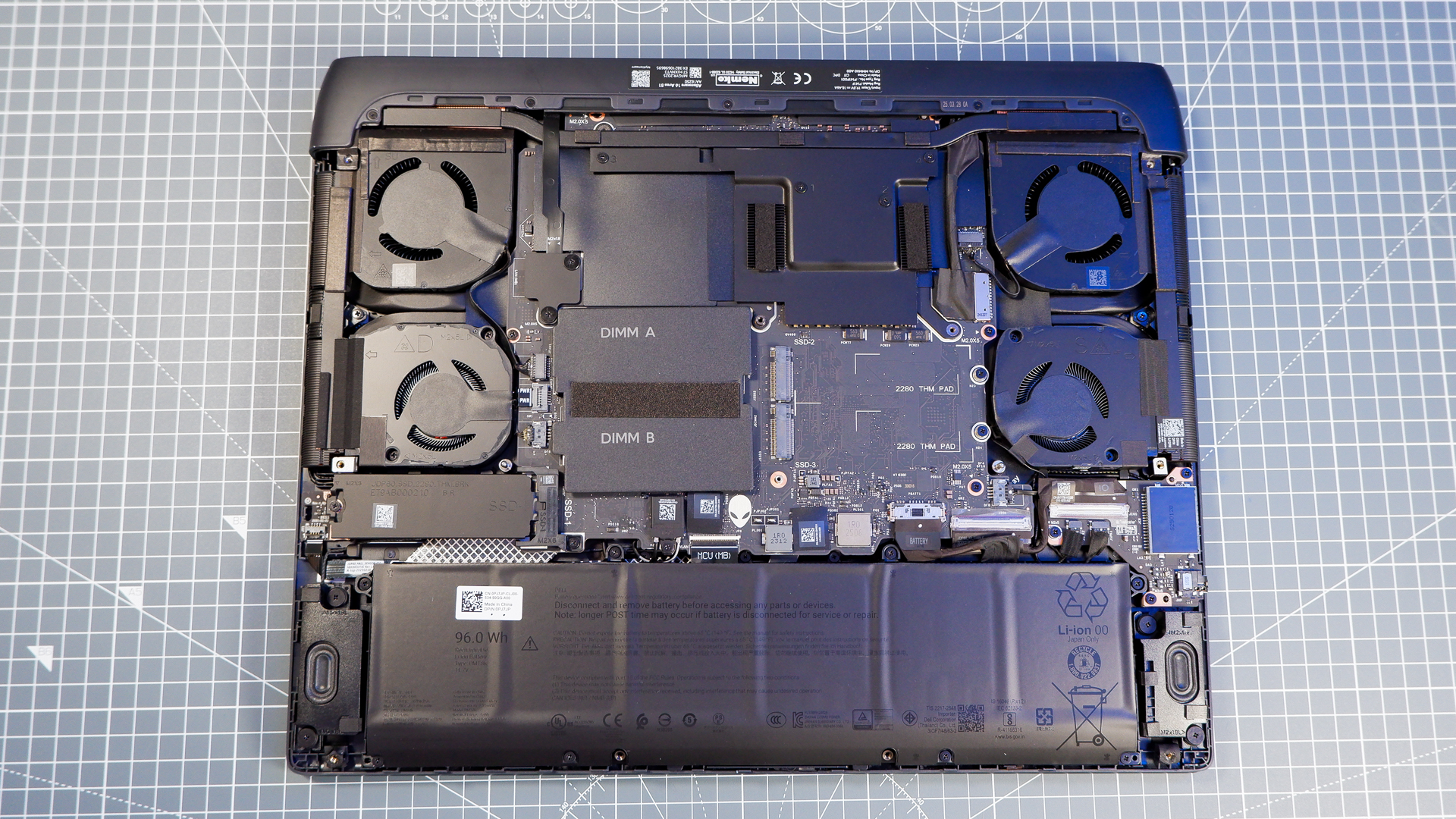 An Alienware 16 Area-51 gaming laptop with RGB lighting in blue on a desk mat.