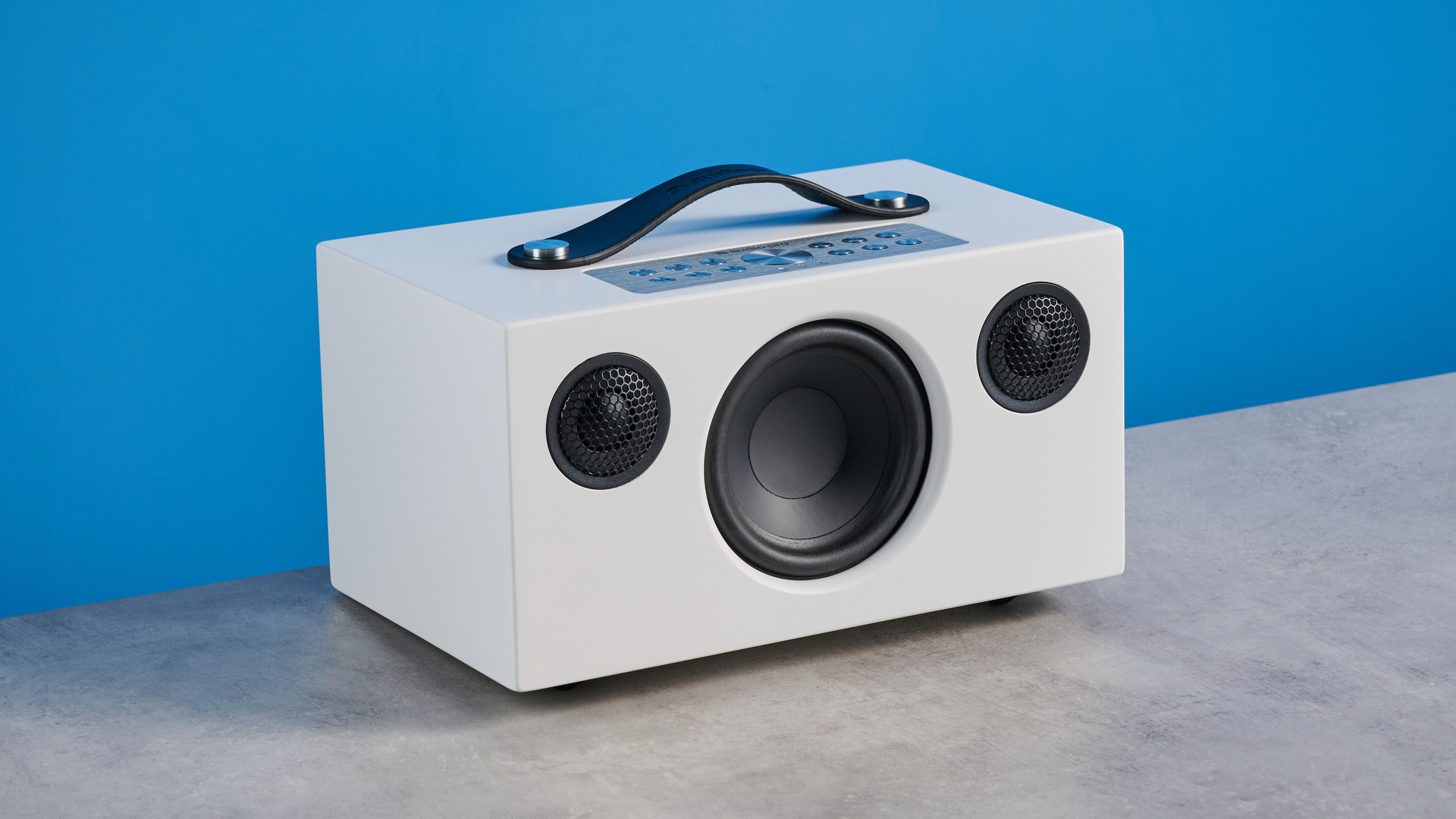 Audio Pro C5 MKII Bluetooth speaker in white photographed on a blue background