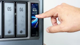 A person interacting with the touchscreen on the front of the Ugreen iDX6011 Pro