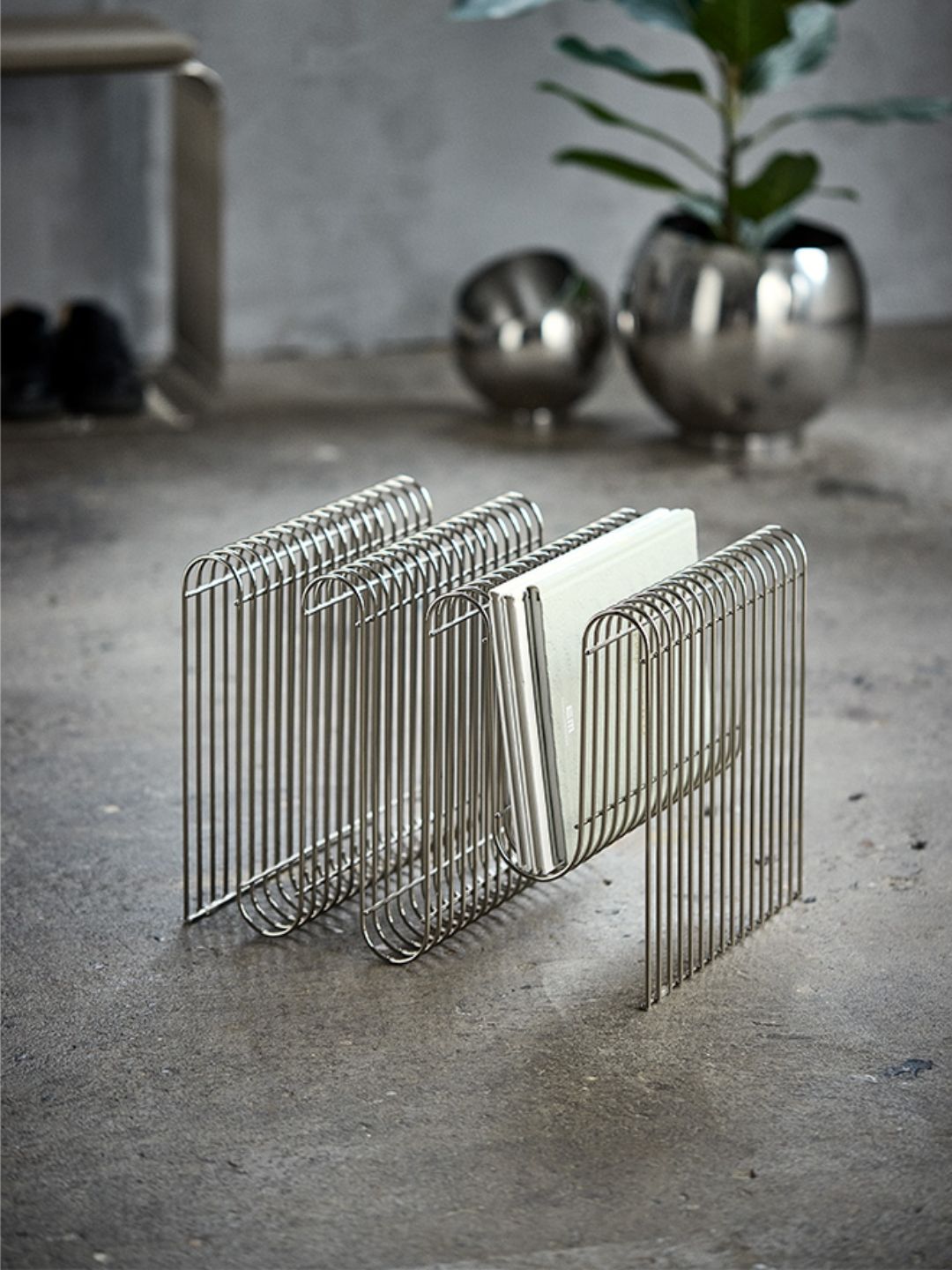A metal curved magazine rack from AYTM