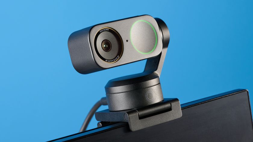 Insta360 Link 2 Pro in graphite black attached to a computer screen photographed on a blue background