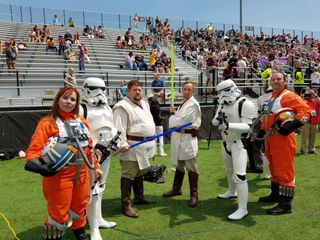 Damien Ann Siegle (left) and members of the Rebel Legion and 501st Star Wars fan groups stand on the field of Saluki Stadium on the campus of Southern Illinois University in Carbondale, Illinois after the total solar eclipse on Aug. 21, 2017. The group greeted spectators at the stadium during the eclipse.