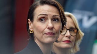 Abigail and Toussaint look to the side in Hostage