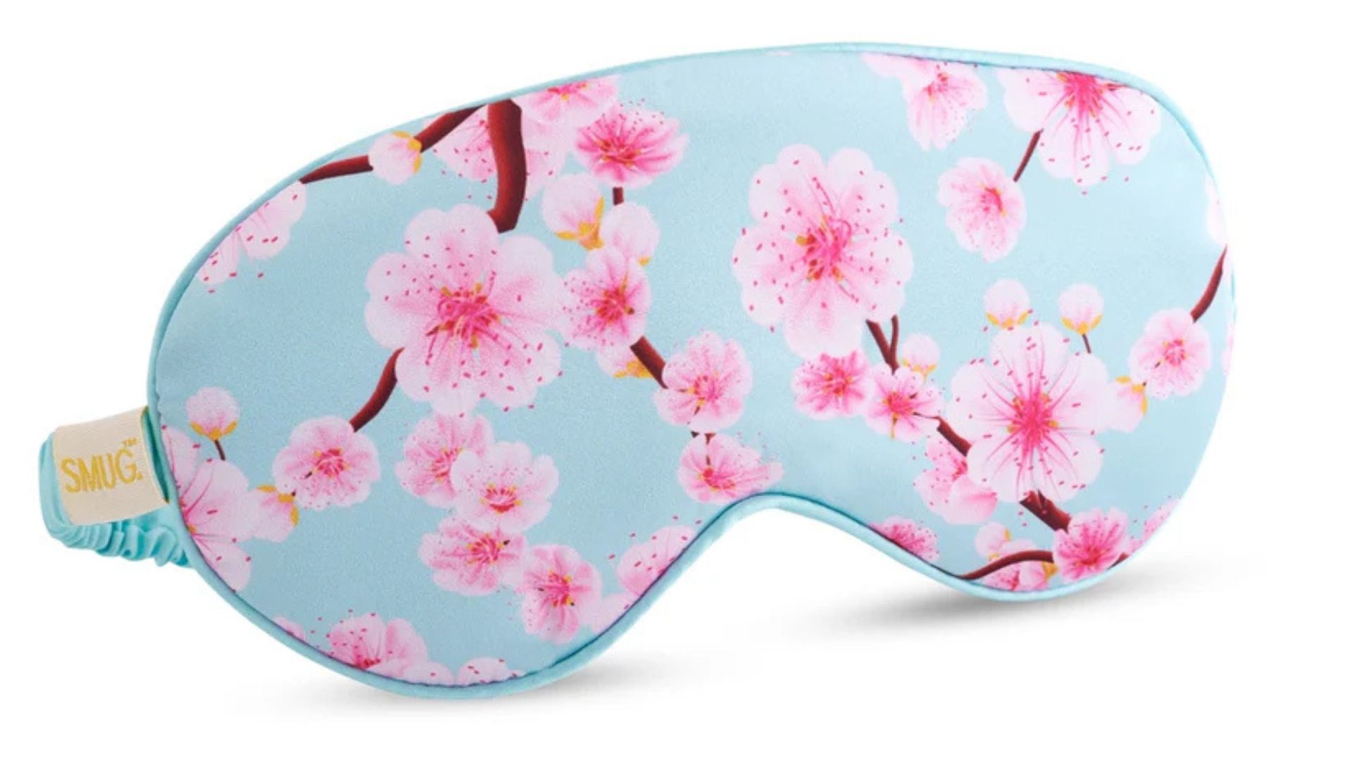 The SMUG Satin Sleep Mask with a cherry blossom pattern on a white background