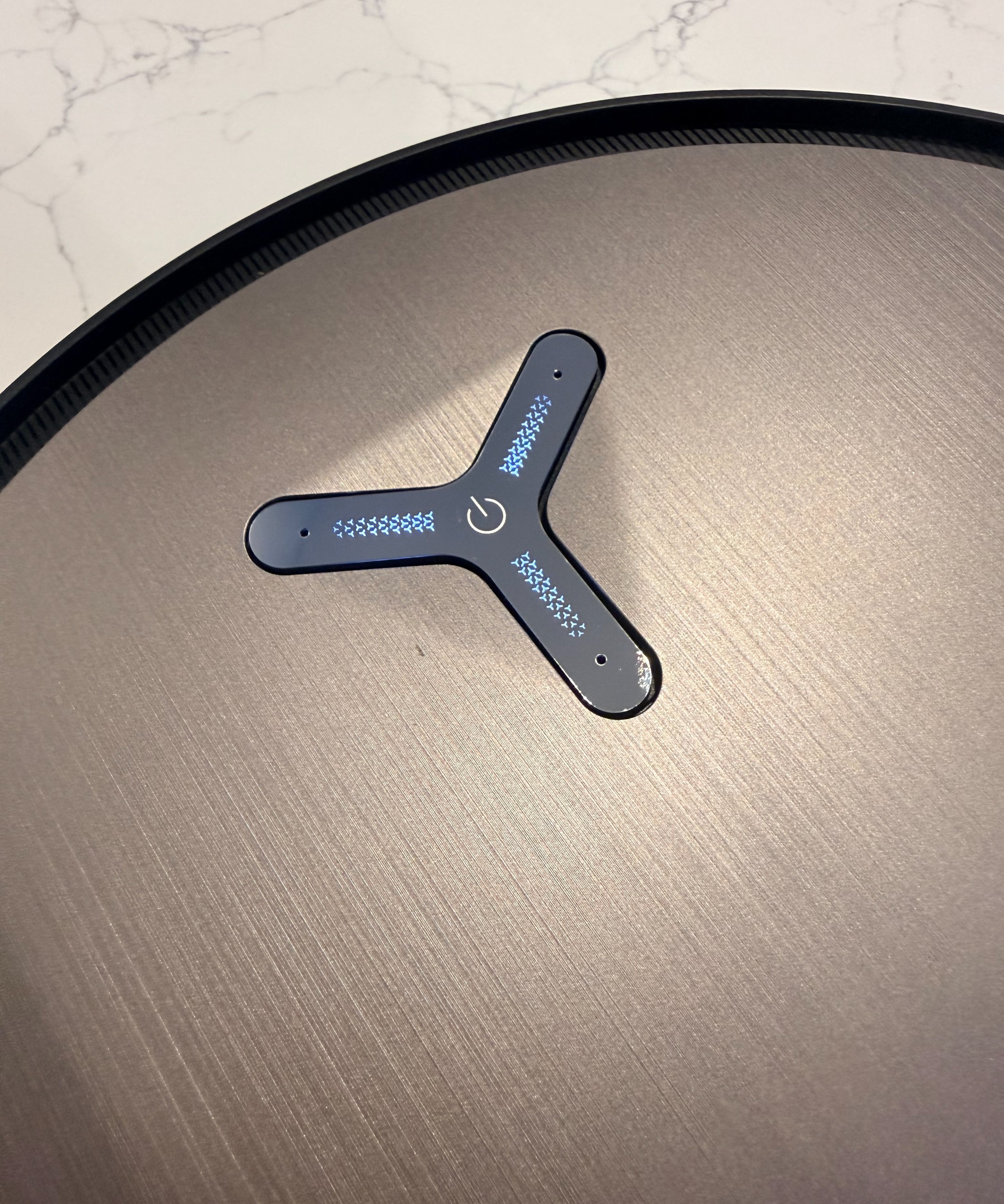 Close-up of illuminated control button on top of ECOVACS DEEBOT X11 OmniCyclone